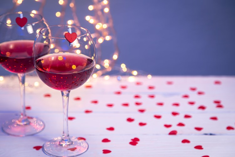 Background with glasses of wine, romantic dinner for Valentine's day concept, copy space.